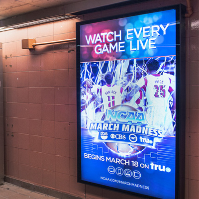 A subway station billboard promoting an upcoming basketball game